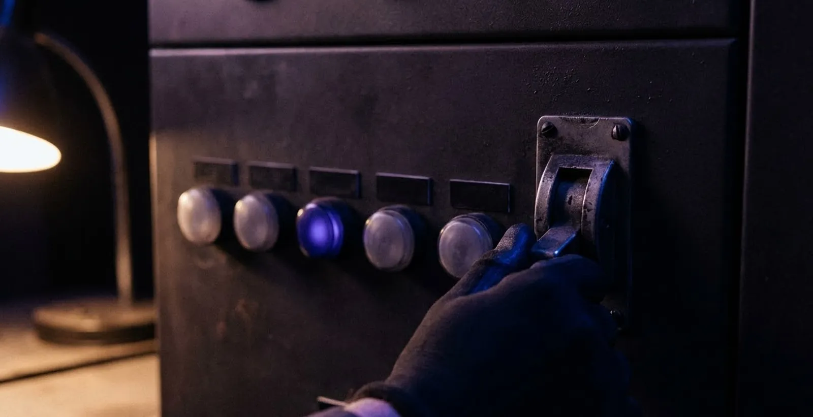 A hand flipping an unlabeled industrial toggle switch on a dark control panel